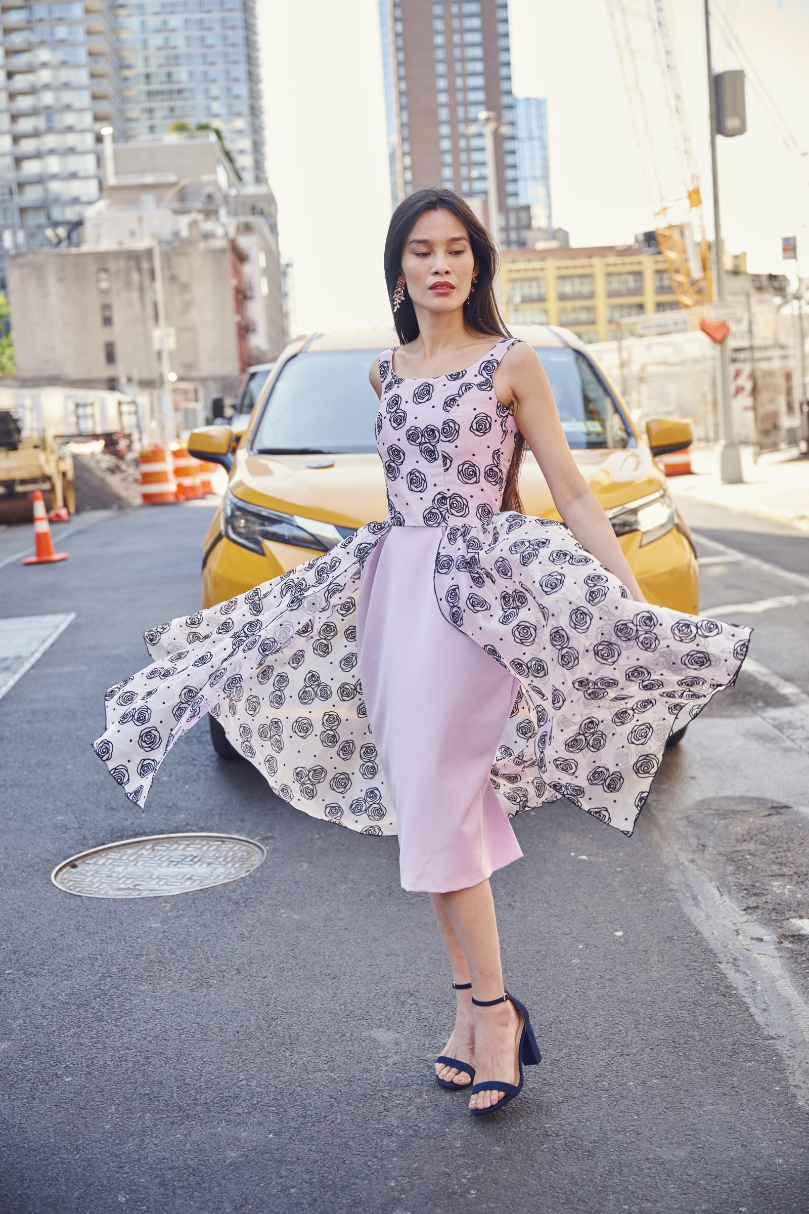 A Gita Omri look worn on a New York street beside a yellow taxi